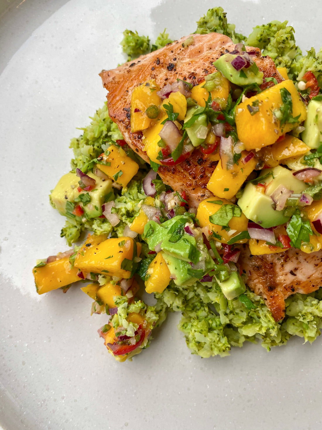 Wasabi broccoli mash with salmon and mango salsa