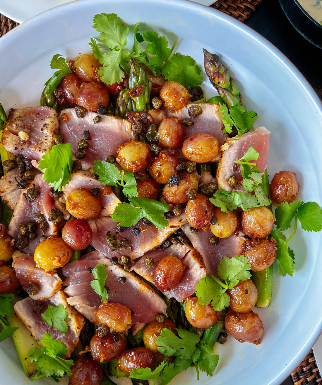 Seared tuna on a bed of asparagus with crispy capers & pan fried grapes (YUM)