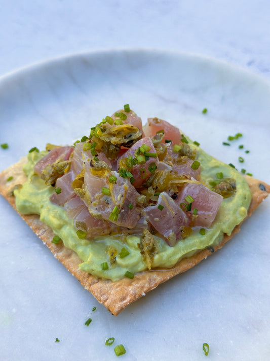 Fish Crudo crackers with whipped an avocado