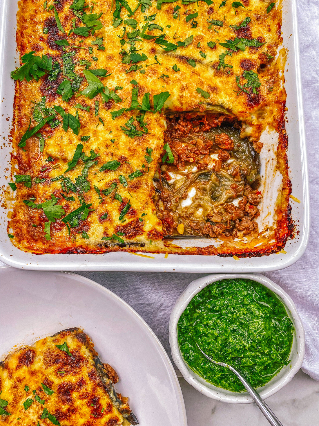 Moussaka with a herby sauce