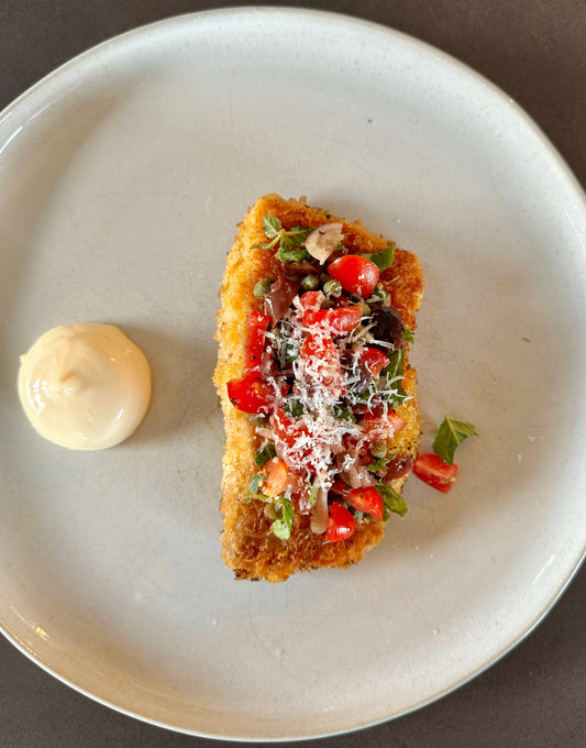 Crispy panko & Parmesan crumbed fish with a tomato, olive, caper & oregano salsa