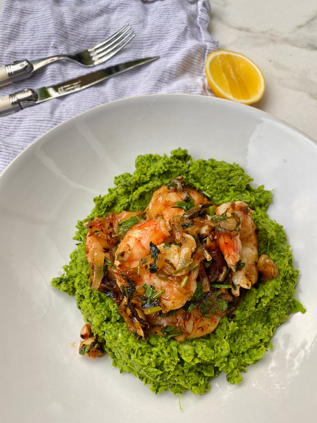 Buttery garlic prawns with a pea and spinach mash