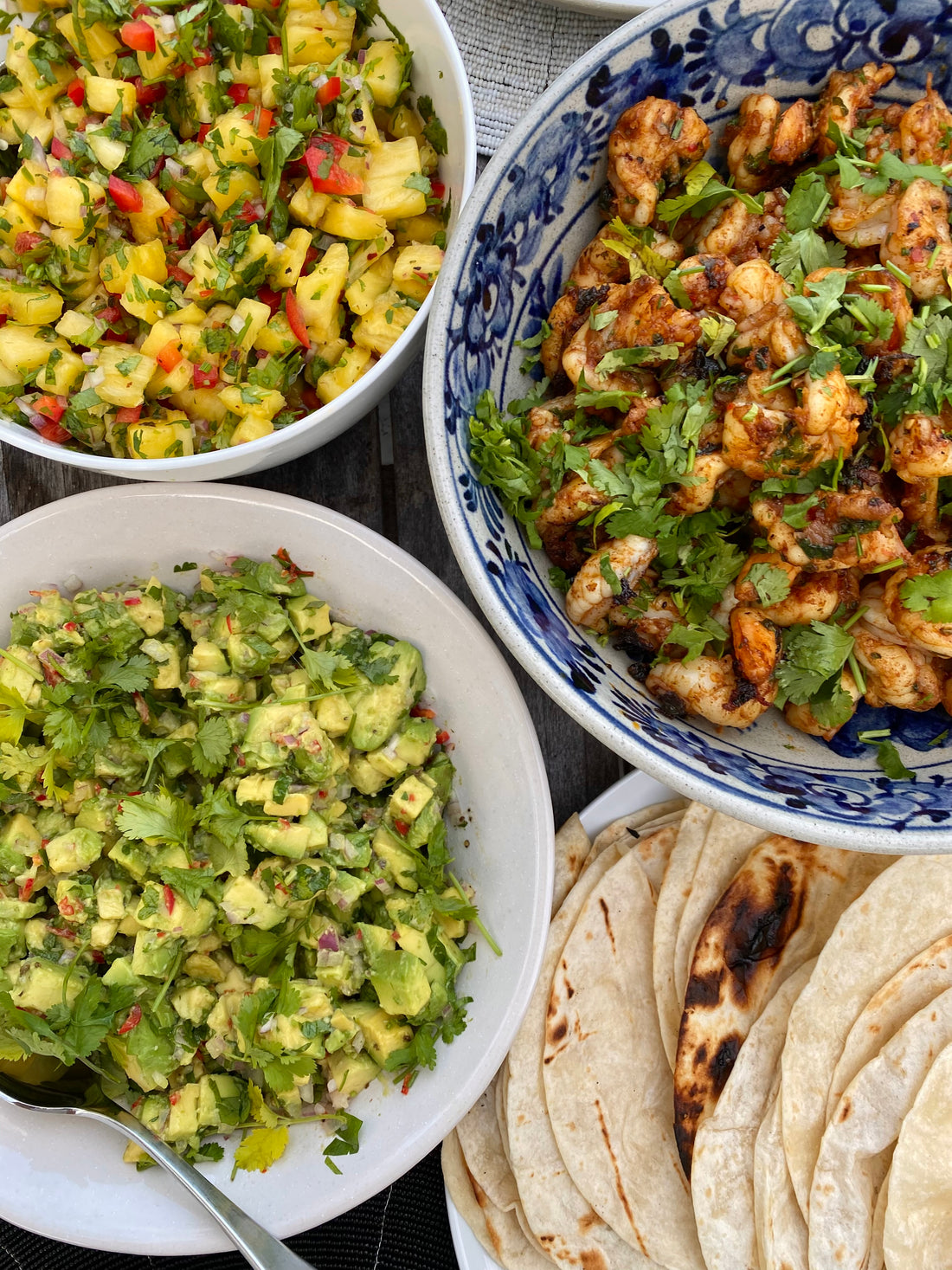 Prawn tacos with pineapple salsa, pickled cabbage and guacamole